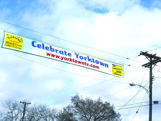 The Yorktown Mardi Gras banner is flying over Main Street under blue skies. Yorktown is getting ready for its first annual Mardi Gras Day on March 1. PHOTOS BY ELE CHEW