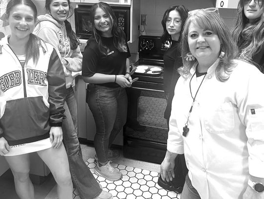 CISD instructor Laura Notaro, right, checks in on students cooking traditional Mexican cuisine. Notaro’s classes allow students to certify as food handlers as well as food service managers. (Contributed Photos)