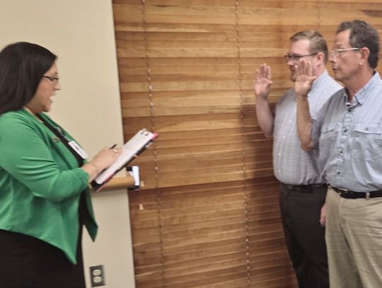 Cuero ISD board members Gerard Gonzales, right, and Sean Douglas take their oaths of of_ce as newly elected trustees. (Staff Photo)