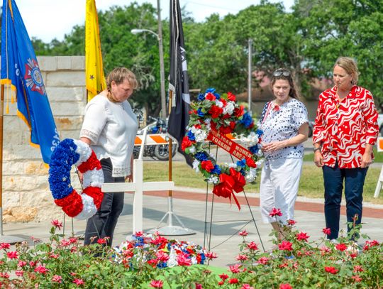 Members of the VFW Auxiliary Post 8136, from left, Valerie Chinnery, Heather Menn, and Laura Wauson laid the wreaths honoring the fallen dead at the May 26 Memorial Day Ceremony. (Photo by Ele Chew)