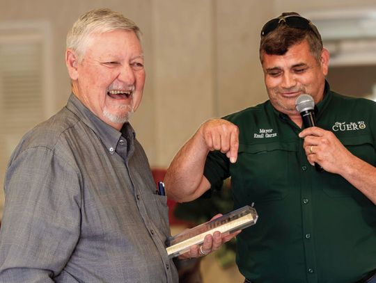 Mayor Emil Garza jokes that, instead of a trip to Ireland, the city presents a crystal plaque to retiring council member Bill Matthys in recognition of his contributions. (Photo by Ele Chew)