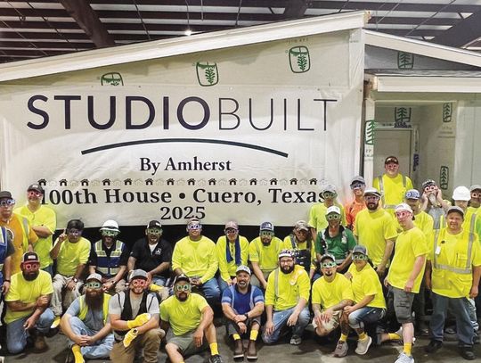 Employees of StudioBuilt gather in the factory to celebrate completion of their 100th modular home on May 20. (Contributed Photo)
