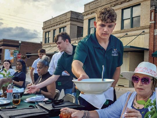 Members of Cuero’s _rst Mayor’s Youth Council and the 4-H served the food at the 6th Annual Hometown Harvest on April 28. Diners had to battle a bit of wind, but made it into a scrumptious dessert from the Mad Batter Bakery. Proceeds from this year’s celebration will bene_t DeWitt 4-H, DeW...
