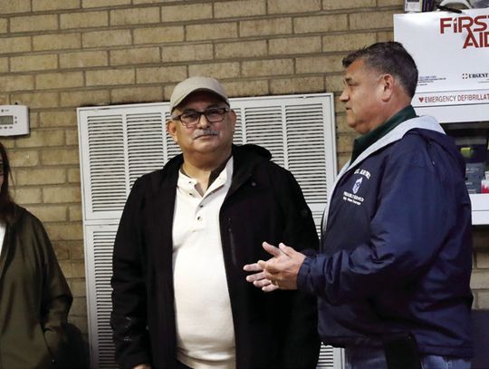 Juan Solis and his wife, Margaret, listen as Mayor Emil Garza congratulates Solis on his retirement from the Cuero Fire Department. The couple has big travel plans for 2025. Meanwhile, the fire department is advertising for a new firefighter. (Staff Photo)