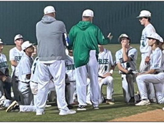 Coach Karl Saenz visits with the team after winning the game vs. LaVernia. (Contributed Photos)