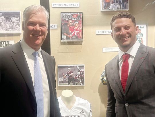 Brad Goebel and Patrick Mahomes in front of their exhibits next to each other at the Texas High School Hall of Fame.