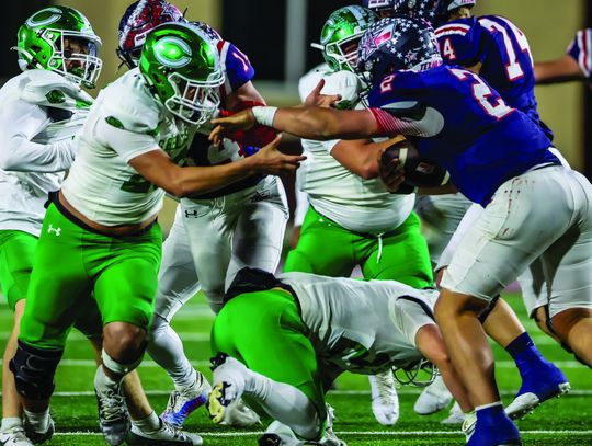 Jace Gamez attempts to make a tackle on Wimberley Quarterback Cody Stover Friday night.