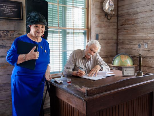 Beverly Bruns, who discovered an original publication of the book in her attic, has Dr. Kearney sign the new release.