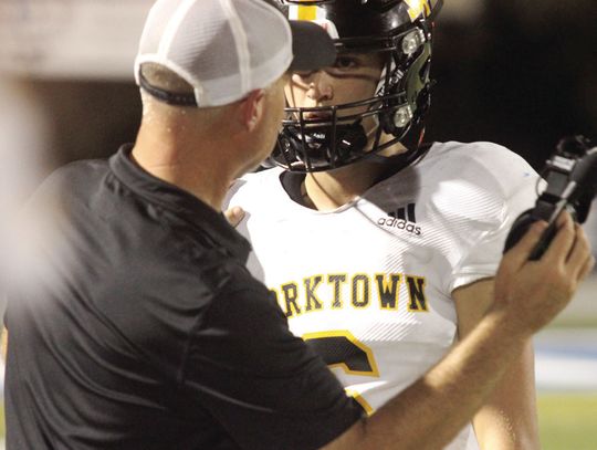 Coach Knostman talks with QB Metting on the sideline. PHOTO BY DEIRDRE ALEXANDER