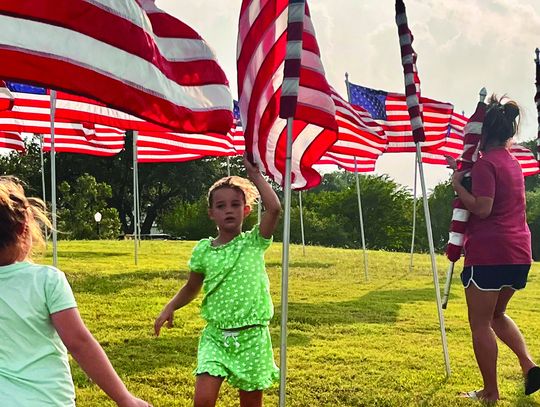 DeWitt County 4-H members gather before Memorial Day to help set up _ags on the Lakeside Knoll in Cuero. Members enjoyed the opportunity to share with the community in honoring all fallen military heroes. (Contributed Photo)