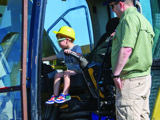 A new driver is testing out the gears at “Touch a Truck” on April 12. See page 4 for the full story. (Photo by Marsha Gibson)