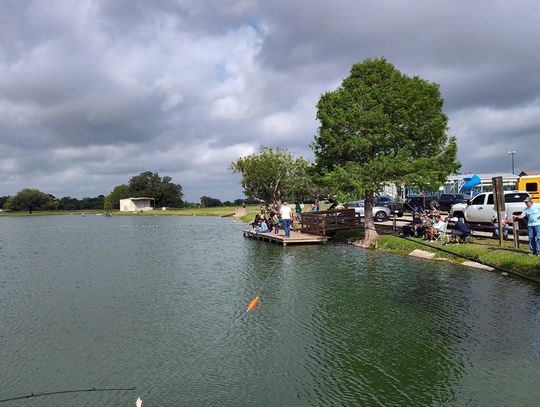 Kids hook catfish in Cuero City Park Lake