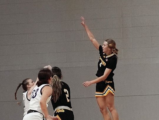 Freshman Palyn Koopmann soars in the air to contest a shot by a Goliad Player. PHOTOS BY VALERIE STUART
