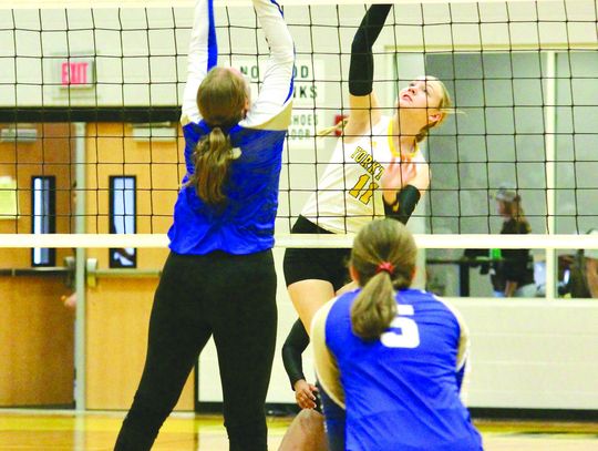 Middle hitter Gracie Stehling kills against Louise in Friday's matchup. PHOTO BY DEIRDRE ALEXANDER