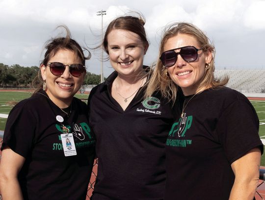 Director of special program Ruby Rodriguez, with School Climate Specialists Courtney Kalinowski and Lacy Timpone, raise awareness of the availability of Mental health resources. (Photo by Ele Chew)