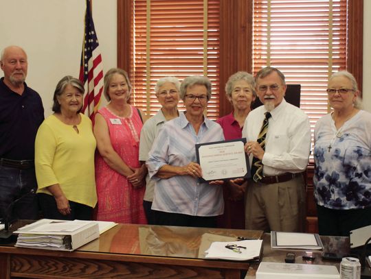 Members of the DeWitt County Historical Commission gather around County Judge Daryl Fowler at Monday’s Commissioner’s Court to celebrate the 2024 Distinguished Service Award from the Texas Historical Commission