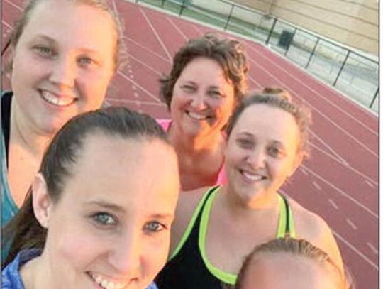 Joanie Hahn, in back, stops for a photo with her daughters, clockwise, Jennifer Hahn, Laura Rochow, Jackie Hernandez and Becky Stakos, while the group walks at the Cuero High School track. The photo won the most likes on The Cuero Record’s Facebook page, earning them a one-year subscriptio...