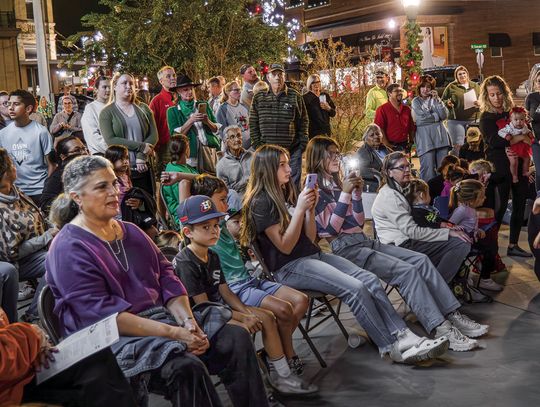 More than 150 people gathered at the library last week for the first Lighting of the Christmas Tree in its new location. The city tree used to be located on Main Street in front of the Graves building, but the library is now its new home. (Photo by Ele Chew)