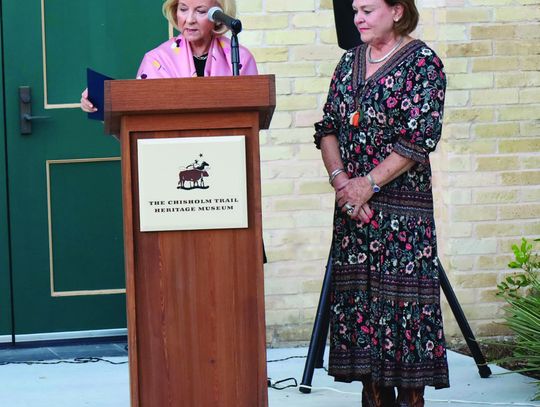 Rep. Geanie W. Morrison reads a state proclamation recognizing the service of outgoing Chisholm Trail Heritage Museum Director Susan Weber. STAFF PHOTO