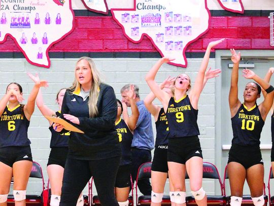 Coach Henkes instructs her team while the bench cheers over a good play. PHOTOS BY DEIRDRE ALEXANDER