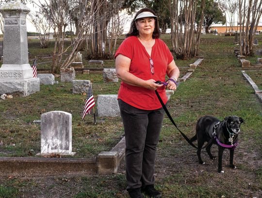 Kaye Kahlich enjoys walking her dog at Hillside Cemetery. If you have fitness goals, Hillside Cemetery is a great place to pursue them, enjoying fresh air while jogging or walking. (Photo by Ele Chew)