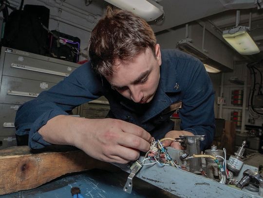 Aboard the USS Abraham, Russell Morehead works on an ejector rack. U.S. NAVY PHOTO BY MASS COMMUNICATION SPECIALIST 2ND CLASS SHERYSSA DODARD