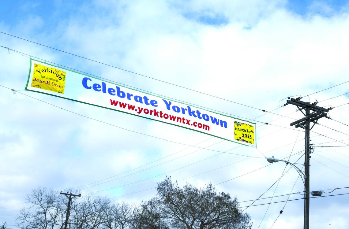 The Yorktown Mardi Gras banner is flying over Main Street under blue skies. Yorktown is getting ready for its first annual Mardi Gras Day on March 1. PHOTOS BY ELE CHEW