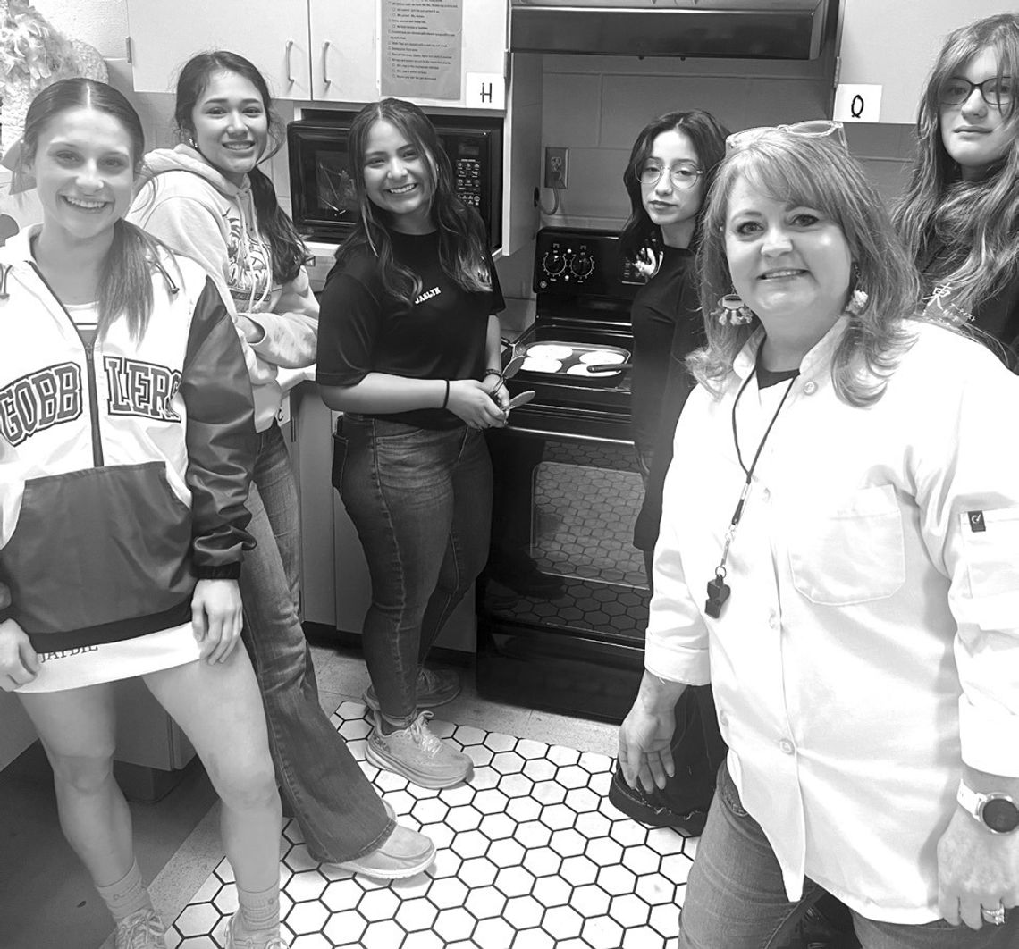 CISD instructor Laura Notaro, right, checks in on students cooking traditional Mexican cuisine. Notaro’s classes allow students to certify as food handlers as well as food service managers. (Contributed Photos)