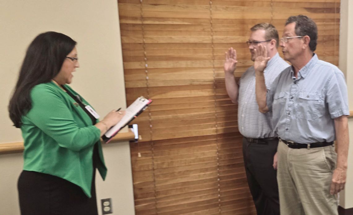 Cuero ISD board members Gerard Gonzales, right, and Sean Douglas take their oaths of of_ce as newly elected trustees. (Staff Photo)