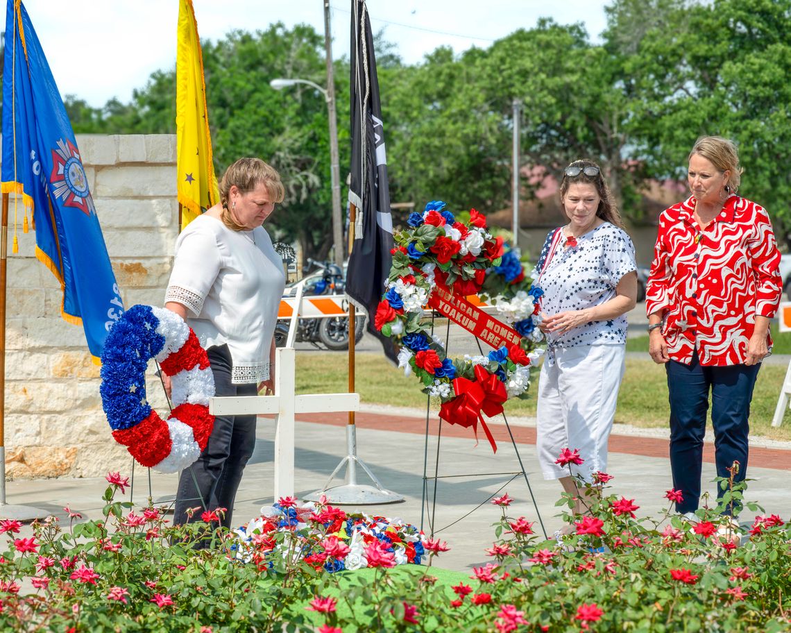 Members of the VFW Auxiliary Post 8136, from left, Valerie Chinnery, Heather Menn, and Laura Wauson laid the wreaths honoring the fallen dead at the May 26 Memorial Day Ceremony. (Photo by Ele Chew)
