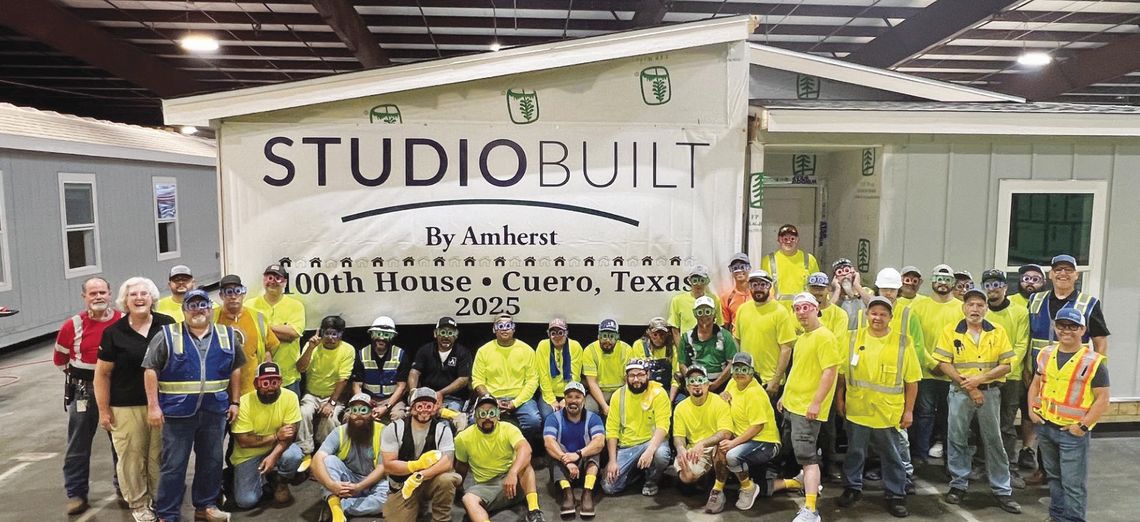 Employees of StudioBuilt gather in the factory to celebrate completion of their 100th modular home on May 20. (Contributed Photo)