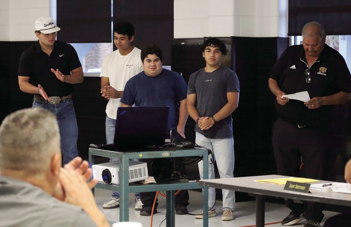 Coach Bruno Mata, right, shares the achievements of the YHS boy’s powerlifting team with the school board. From left, the team included Rylan Rau, Manuel Macias, Justin Guerrero, and Johnathan Guerrero. Rau placed 5th at state and Johnathan placed first. STAFF PHOTO
