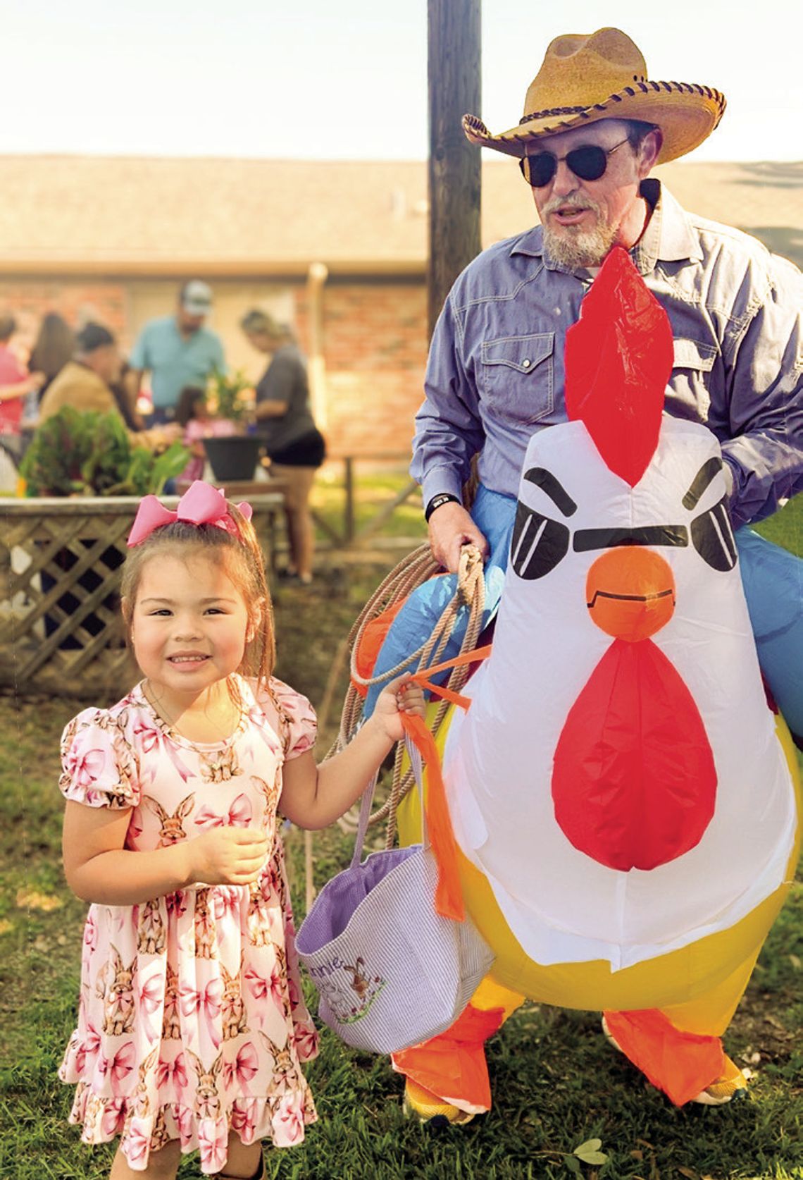 Annie Naranjo (L-R) shows her Easter egg basket to Yorktown Lions Club President Elect Mark Black aka Rowdy Rooster at Yorktown Community-Wide Easter Egg Hunt on April 12. PHOTOS BY KATIE NEWMAN