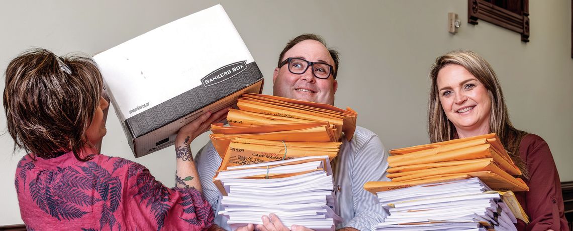 24th Judicial District Attorney Brian Cromeens and District Administrator Whitney Smith strain under the paper load of _les that are equivalent to 50 court cases. That is half of a typical court docket of 120 cases. Meanwhile, Leigh Ann Harryman continues to add more _les to their workload...