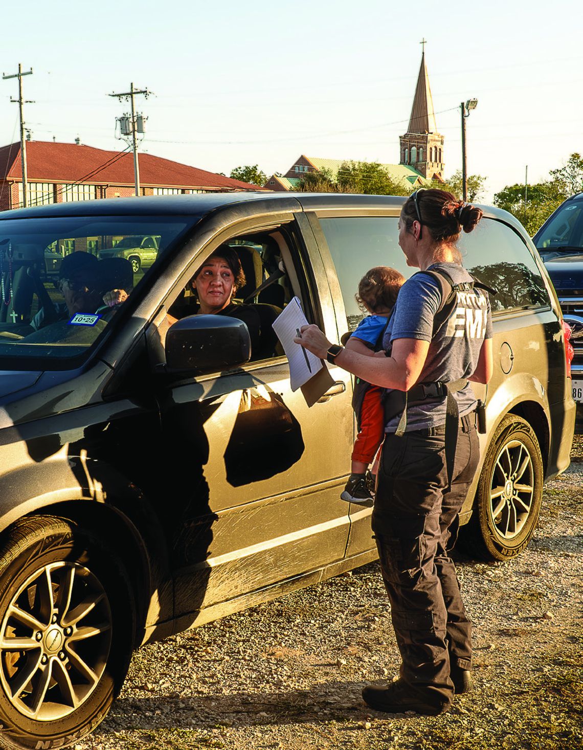 Executive Director Terri Rogers, with a baby on her back, checks the orders. PHOTO BY ELE CHEW