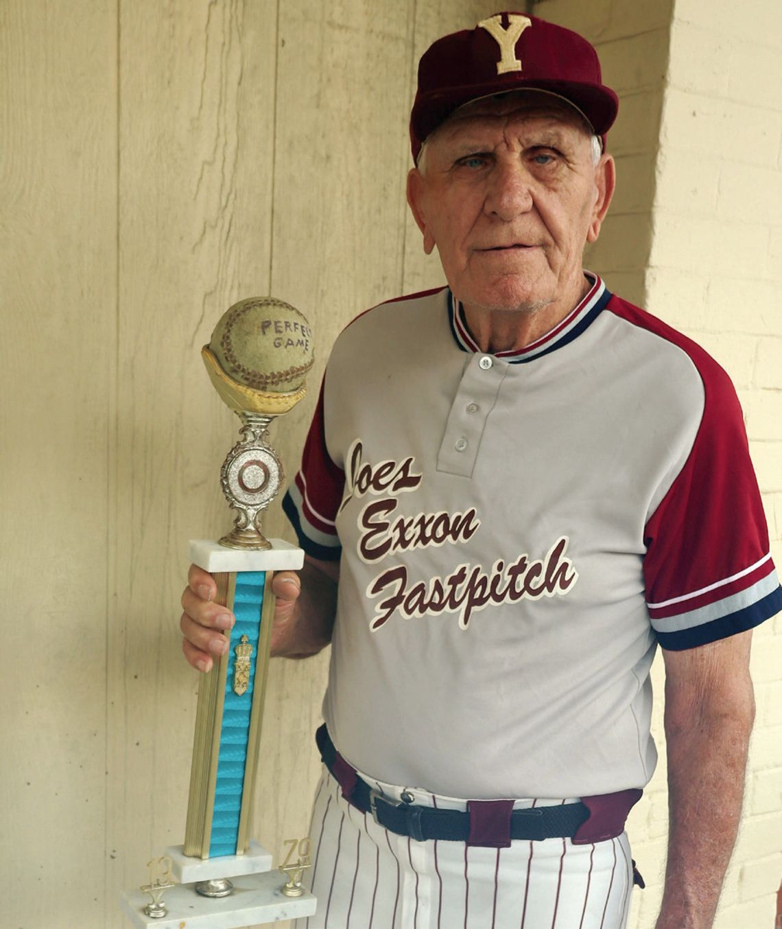 Roger Weise, 85, holds his Perfect Game trophy from a 1979 game he pitched. Weise and two fellow fastpitch teammates from Yoakum will be inducted into the FastPitch Legends Hall of Honor on November 16. (Staff photos)