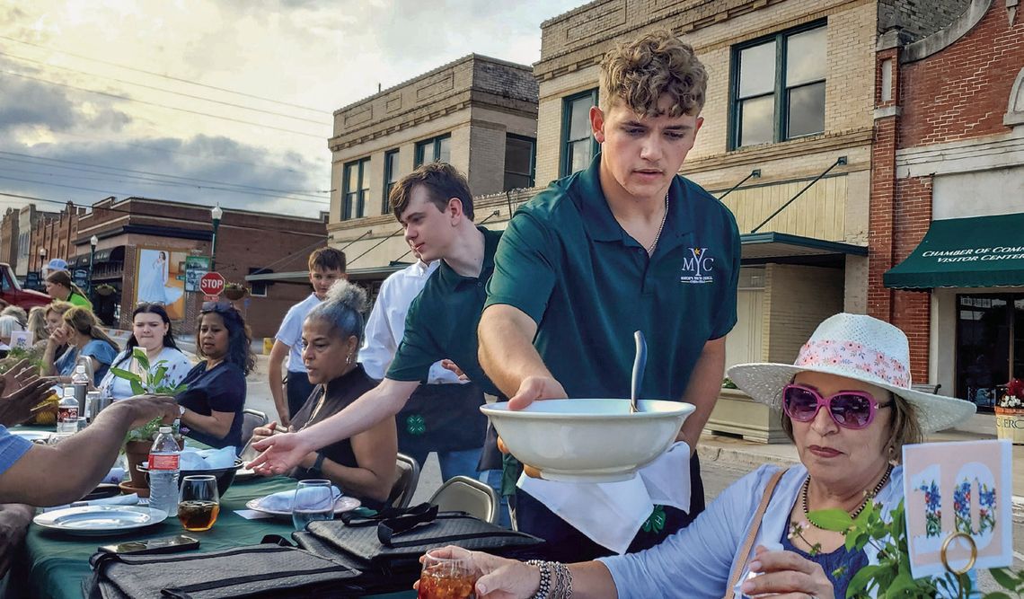 Members of Cuero’s _rst Mayor’s Youth Council and the 4-H served the food at the 6th Annual Hometown Harvest on April 28. Diners had to battle a bit of wind, but made it into a scrumptious dessert from the Mad Batter Bakery. Proceeds from this year’s celebration will bene_t DeWitt 4-H, DeW...
