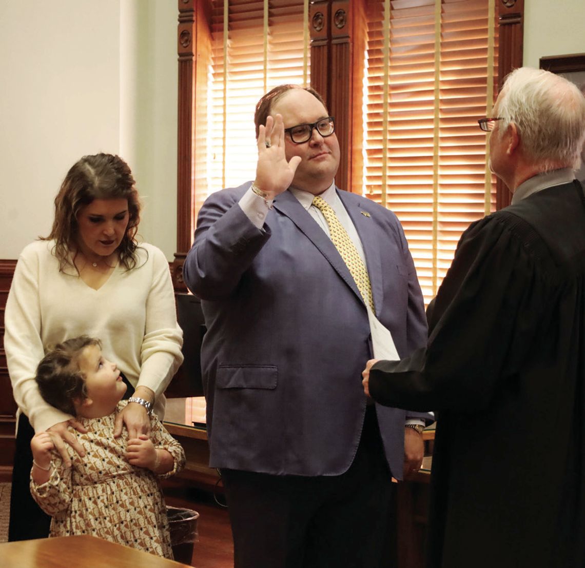 Brian Cromeens, the new 24th Judicial District Attorney, takes the oath of office on January 1 accompanied by his wife, Maggie, and daughter Libby. District Judge Stephen Williams administered the oath. STAFF PHOTO