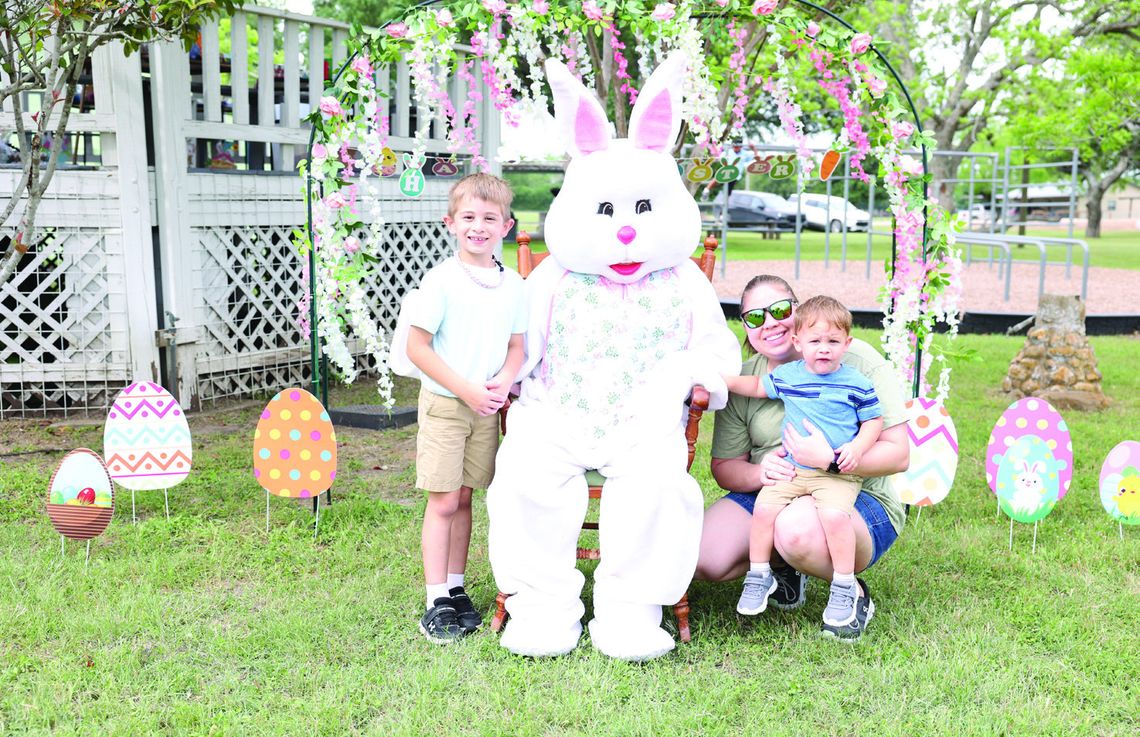Children at the 38th Annual Nordheim Easter Egg Hunt met Penny Cottontail. From left, Carter, Penny Cottontail, and Candace Reynolds holding Colson. PHOTO BY ELISHA TAM