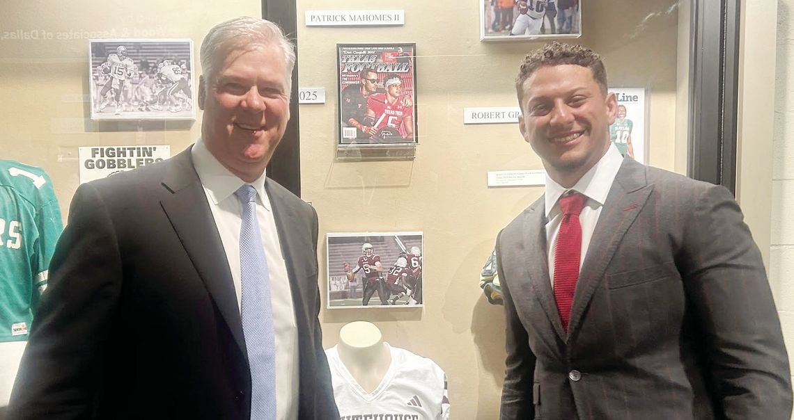 Brad Goebel and Patrick Mahomes in front of their exhibits next to each other at the Texas High School Hall of Fame.