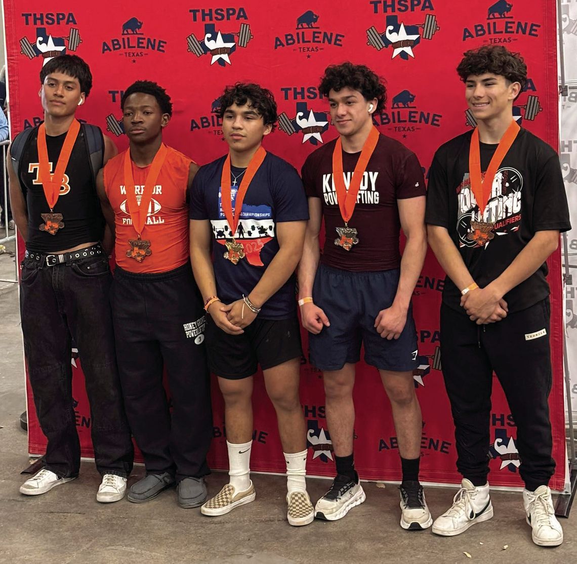 Wildcat senior Johnathan Guerrero (center) won the State Powerlifting Championship in the 132 pound weight class.