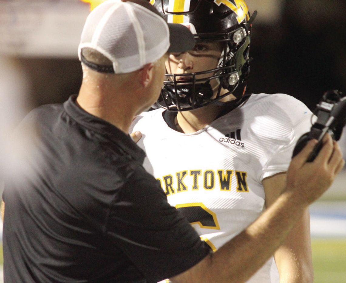 Coach Knostman talks with QB Metting on the sideline. PHOTO BY DEIRDRE ALEXANDER
