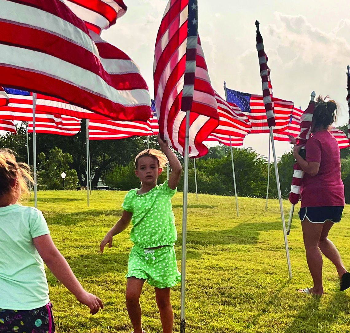 DeWitt County 4-H members gather before Memorial Day to help set up _ags on the Lakeside Knoll in Cuero. Members enjoyed the opportunity to share with the community in honoring all fallen military heroes. (Contributed Photo)