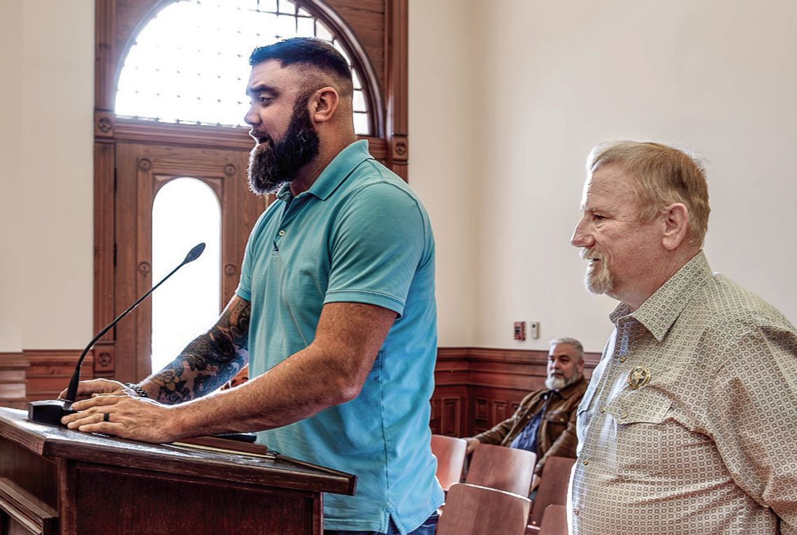 Adam Fanning, left, with Brandt Companies, and Sheriff Carl Bowen, right, present a report to the Commissioners Court regarding the jail’s failing hot water heaters. PHOTO BY ELE CHEW
