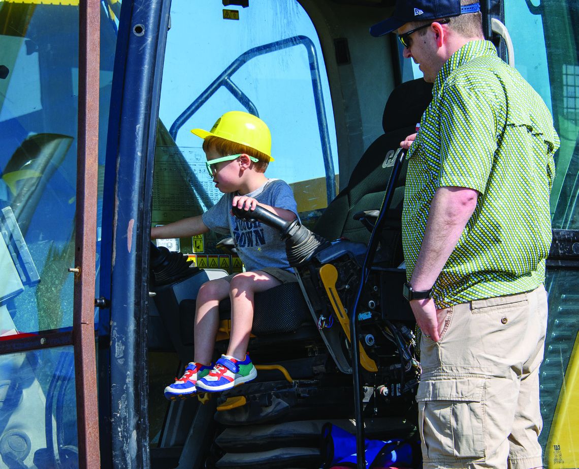 A new driver is testing out the gears at “Touch a Truck” on April 12. See page 4 for the full story. (Photo by Marsha Gibson)
