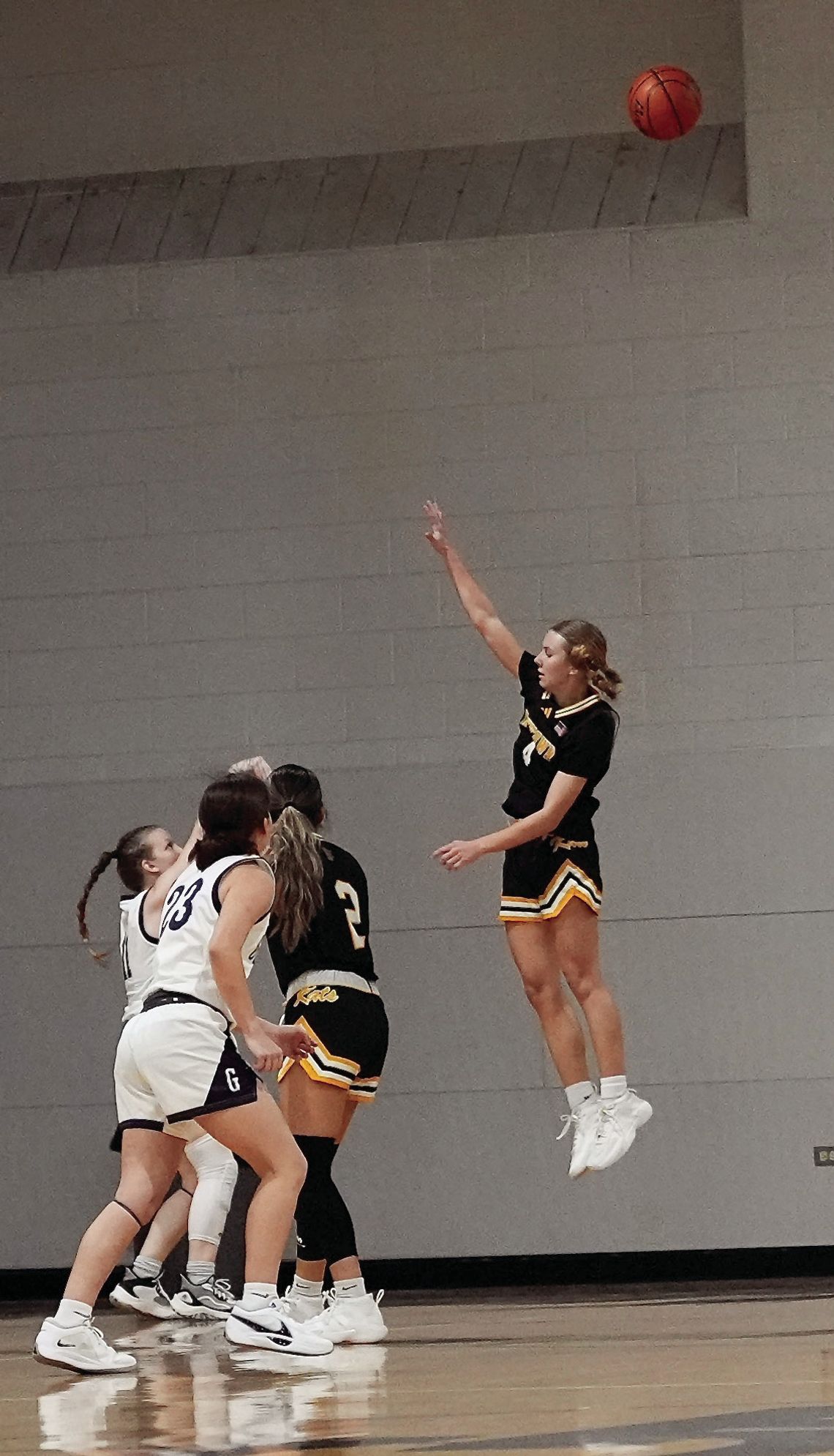 Freshman Palyn Koopmann soars in the air to contest a shot by a Goliad Player. PHOTOS BY VALERIE STUART