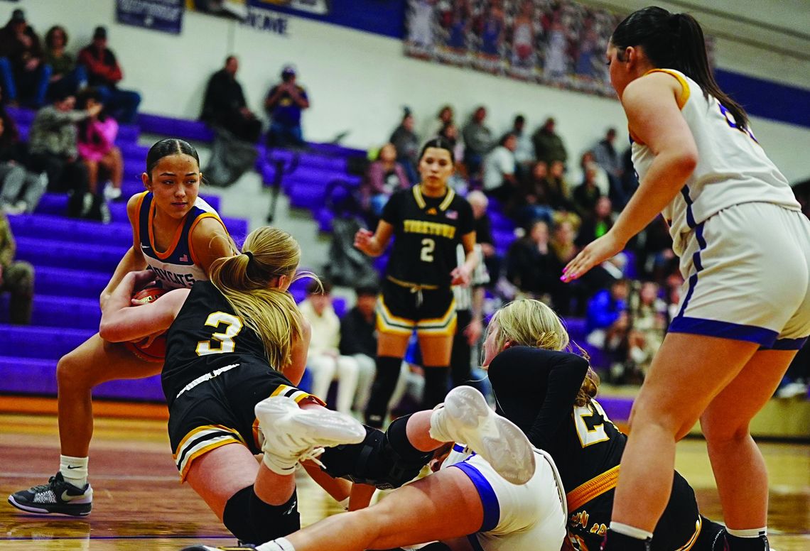 Kitty Kat seniors Sydnie Krueger (left) and Laynie Boyd (right) battle Skidmore players for the ball, while Nina Villarreal (center) looks on. PHOTO BY VALERIE STUART
