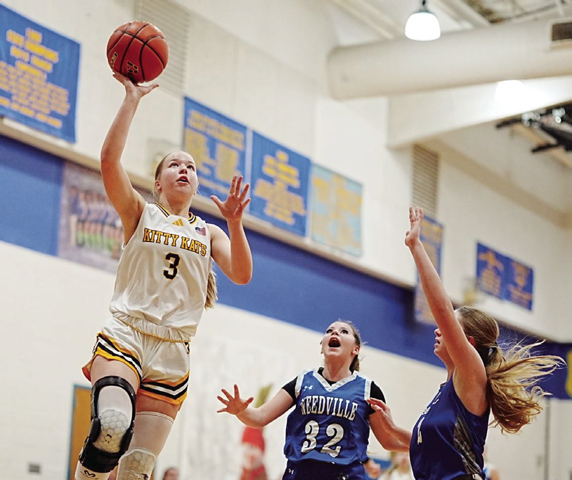 Kitty Kat senior Sydnie Krueger goes up for two points against Needville on December 27. The team won 53-19 in its first game of the tournament in Louise. PHOTOS BY VALERIE STUART