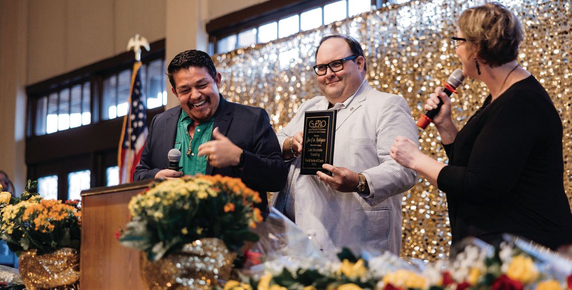 Weber Motor Company’s Jon Eric Rodriguez, left, won the World Series of Cuero “Last Business Standing” award at the Cuero Chamber of Commerce “Carnival of Success” banquet on March 13. Rodriguez and Emily Weatherly, right, emceed the evening, so District Attorney Brian Cromeen, center, pre...