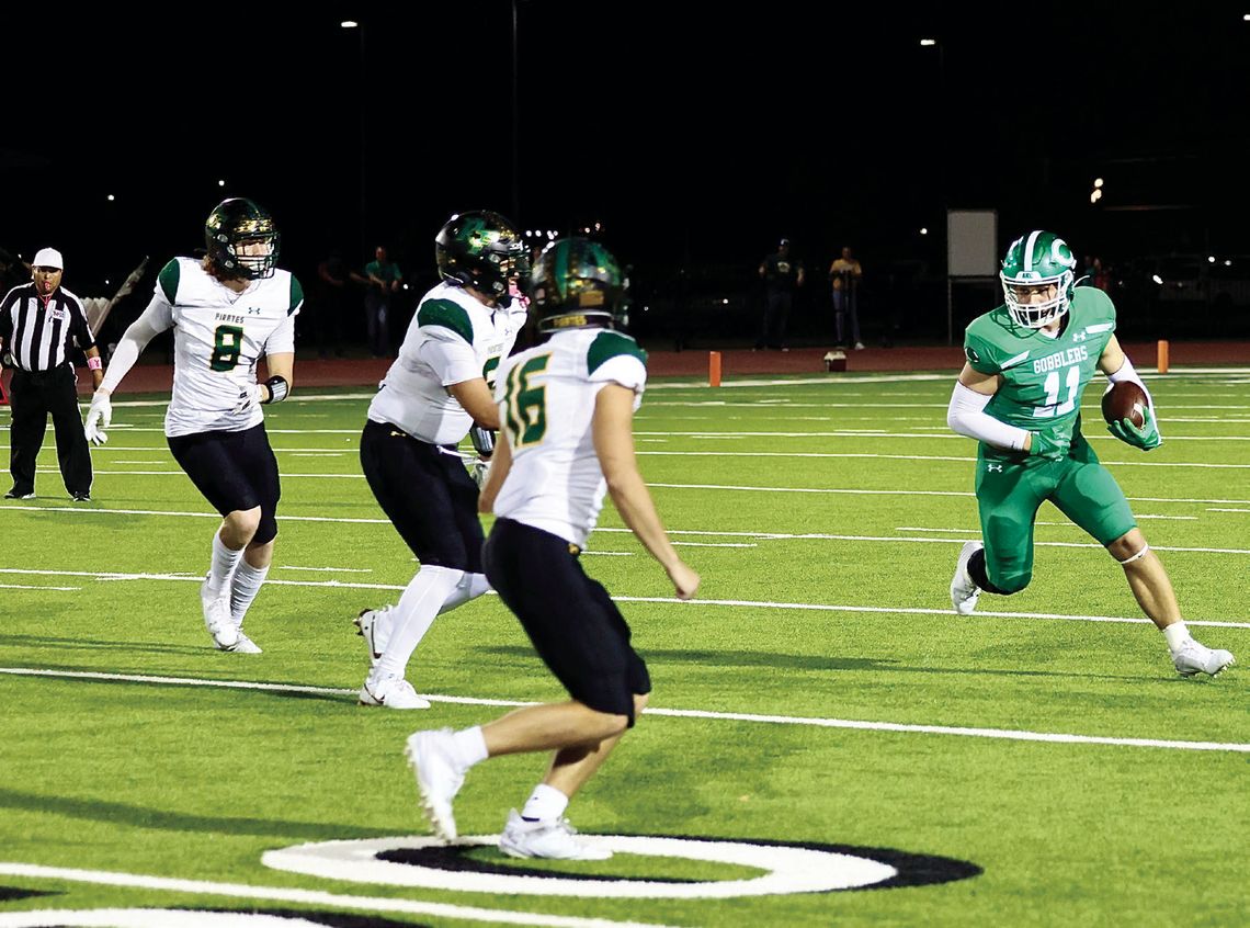 Conner Kubesch rushes for yards against Rockport in the Gobbler’s first district game. (Photo by Mike Cantu)